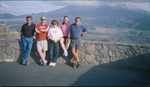 Five People Posing In Front of Scenic Backdrop