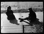 Tots- Don And Barbara Sit On Sidewalk by George French