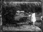Tots- Two Little Girls (Barb And Bun) On Hill Looking Down On Farm Buildings by George French