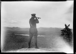 Will French, Game Warden Using A Telescope To Scan The Countryside From A Hilltop. by George French
