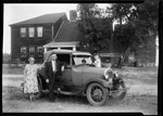 Family Standing Beside A Car Outside House Shot Titled "Eclipse Fliver" by George French