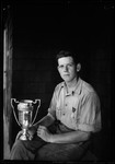 Don French Holding Horseshoe Pitching Trophy by George French