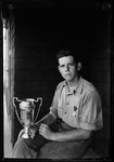Don French Holding Horseshoe Pitching Trophy by George French