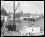 Men Unload Lobsters (in Car), In Boothbay Harbor, From Boat At Dock, Men On Dock, Harbor Behind by George French