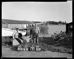 Two Men With Clam Rockers On Shore Near Boats, Lock Dock Behind In North Haven by George French