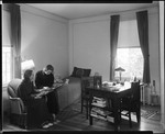 Two Girls Looking At Photo Album In Their Room At Bates College by George French