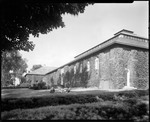 Long View Of Ivy Covered Building, Students Sit Out Front At Bates College by George French