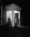 Two Students Smoke A Pipe On Front Porch Of Building At Bates College by George French