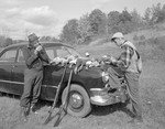 Vern And Jim By Car, Vern Lights Pipe, Jim Looks Over Many Birds On Hood Of Car, Guns Lean Against Fender, Field Behind In Porter by George French