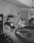 Man And Woman Read By Fireplace by George French