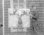 Mr Decker, A Wood Carver, Stands By A Deer Head He Carved In Dark Harbor by George French