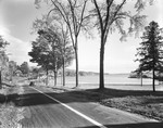 Road Leading Into Town Of Harrison, Lake On Right by George French