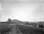View Of Road By Androscoggin River, Mountain Range Beyond by George French