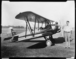 Man Standing In Front Of A Bi-wing Airplane by George French