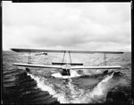 Man Sitting Inside Of A Glider Being Towed Along In The Water by George French