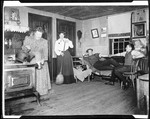Ma, George French's Mother, Pouring From A Kettle On Stove, Mable Sweeping Floor, Cats In Chair, Two Males Sitting At Right--Kezar Falls by George French