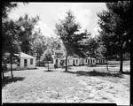 Row Of Cabins With People Sitting Outside, Goodwin's Cabins In North Sebago by George French