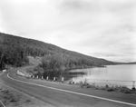 Blacktop Highway Along A Sweeping Lake Shore by French George