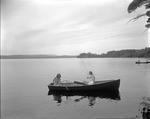 Two Girls Out Fishing, One Netting The Others Catch On Long Lake In Naples by French George