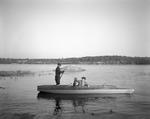 Two Duck Hunters In Camouflaged Boat by French George