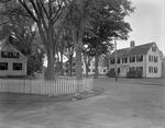 Shot On Corner Of Street Showing White Picket Fence, Trees And Houses by French George