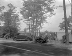 Family Setting Up A Tent In A Camping Area In Sebago by French George