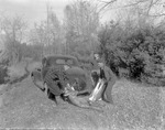 Two Hunters Loading A Buck Onto Their Car by French George