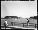 Man Taking A Picture Of A Young Girl On A Dock Near Five Islands by French George