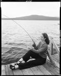 Woman Sitting On Wharf In Rangeley Fishing, Lake And Mountains In Background by French George