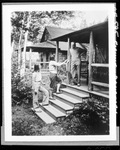 Two Girls Showing Off Nice Catch Of Fish To Man On Camp Porch by French George