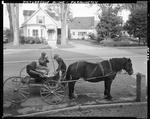 Two Men Standing Beside A Horse Drawn Carriage In Front Of A House In Farmington, One Is Showing Apples To The Other by French George