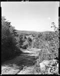 View Down A Dirt Road Toward A Distant Mountain In Cornish by French George