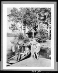 Man And Woman In Boat Showing Days Catch To Two Men On Dock At Pleasant Island Camps, Rangeley by French George