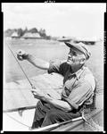 Man Sitting On Dock Rigging Fishing Rod (Close In Portrait Type Shot) At Upper Dam by French George
