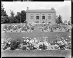 Extensive Flower Gardens Outside A Brick Building In Rangeley by French George