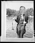 Gag Shot Of Harold Holding A Fish by George W. French