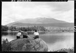 Three Women Sitting On A Rock Beside A Lake, Mount Katahdin In The Distance by George W. French