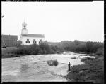 Church On Opposite Shore Of Stream Where A Man Is Fishing In Columbia Falls by George French
