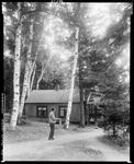 One Man Standing Next To Camp Holding A Fish In Jackman by George French