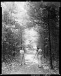 Man & Woman Setting Up To Photograph A Woods Trail In Jefferson by George French