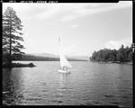 Small Sailboat On Kezar Lake In Kezar Falls, Mountains In Distance by George French