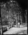 Couple Walking Along A Gravel Path Near Some Camps On Kezar Lake by George French