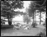 Group Of Women Sitting Around On A Lawn Near A Lake In Lovell by George French