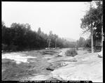 Man Sitting On Rocks Near Rapids At Middle Dam by George French