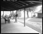 People Sitting On Porch Of Camp At Middle Dam by George French