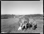 Two Partridge Hunters And A Dog By A Car In A Field In Parsonsfield by George French