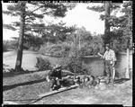 Two Men At Campsite, One Holding Fish Other About To Fillet His In Parsonsfield by George French