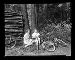 Two Girls Eating A Picnic Lunch After A Morning Of Bicycling by George French