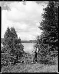 Man With A Backpack Standing Near A Lake In Porter by George French