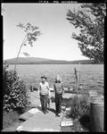 Man And Woman Standing On Pier Holding Salmon At Grants At Kennebago by George French